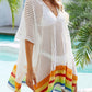 Woman wearing slit openwork V-neck half sleeve cover-up by the pool, showcasing colorful striped hem, made of 100% polyester.