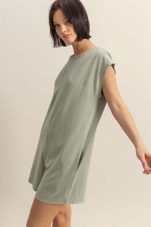 Model showcasing a breezy green cap sleeve romper, perfect for warm weather and casual outings.