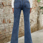 Stylish Bella Road Denim Bootcut Jeans with pockets, showcasing a flattering backside view against a rustic wall.