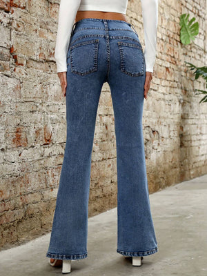 Stylish Bella Road Denim Bootcut Jeans with pockets, showcasing a flattering backside view against a rustic wall.