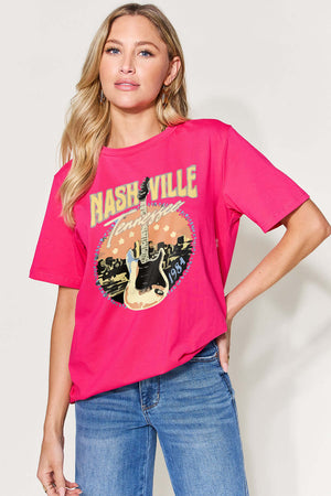 Woman wearing a graphic round neck short sleeve red T-shirt with "Nashville, Tennessee" print, paired with blue jeans.