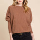 Woman wearing BOMBOM Drop Shoulder Long Sleeve Knit Top in brown with casual shorts, showcasing a stylish dolman sleeve design.