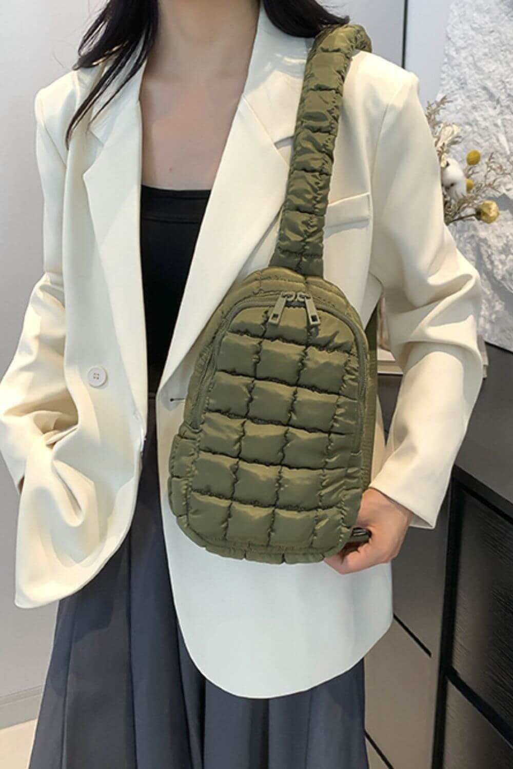 Stylish woman with Bella Road Quilted Nylon Crossbody Bag in green, perfect for trendy outfits and everyday adventures.