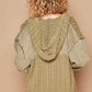 Back view of a stylish olive green distressed hem hooded cardigan with curly hair model. Perfect for casual layering.