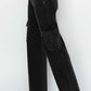 Side view of Risen Jeans - High Rise Wide Leg Cargo Jeans showcasing cargo pockets and wide-leg silhouette in a sleek black color.