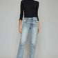 Stylish woman modeling High Waist Button Fly Raw Hem Cropped Straight Jeans with black top