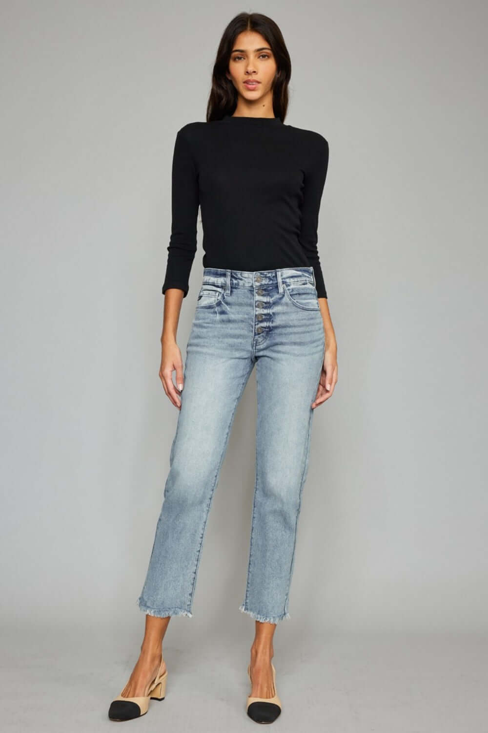 Stylish woman modeling High Waist Button Fly Raw Hem Cropped Straight Jeans with black top