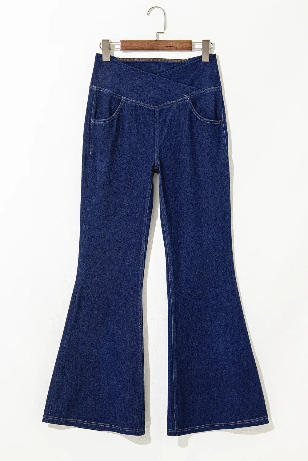 Asymmetric Waist Flare Jeans with moderate stretch and pocket detail, made from polyester, cotton, and elastane.