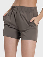 Millennia elastic waist active shorts with pockets, featuring moderate stretch and comfortable fit for workouts.