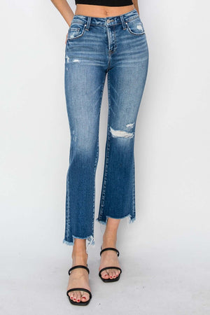 Model wearing Risen Jeans frayed step hem ankle straight jeans, showing off edgy and chic distressed denim style.