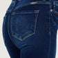 Close-up of high rise frayed ankle skinny jeans back pocket detailing