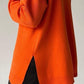 Cozy orange sweater with side slit, turtleneck, and dropped shoulders for a chic and relaxed style.