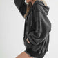 Stylish woman wearing a dark gray Exposed Seam Zip Up Drawstring Hooded Jacket, showcasing its trendy design and comfort.