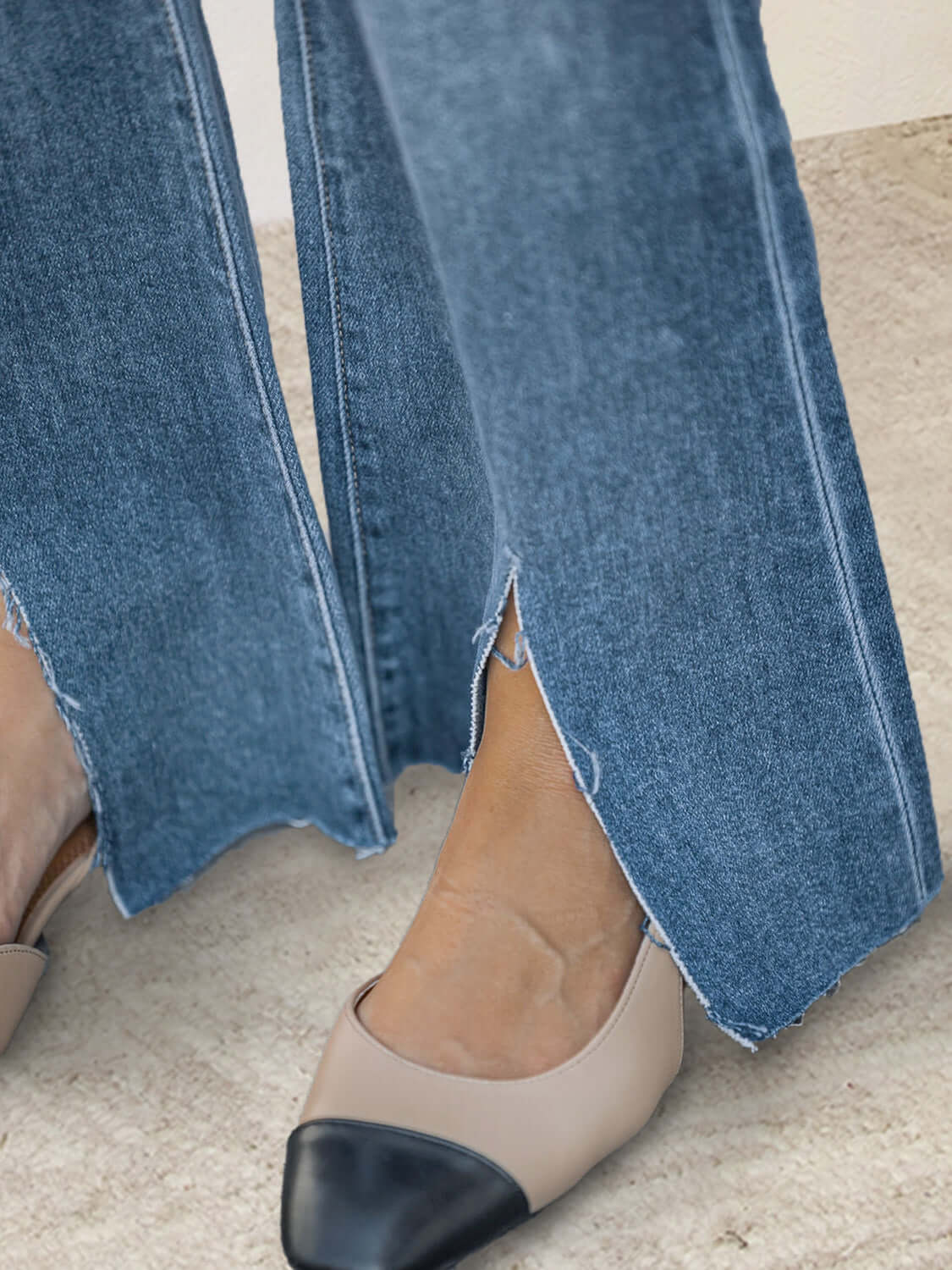 Close-up of Bella Road Slit Bootcut Jeans with Pockets and two-tone shoes