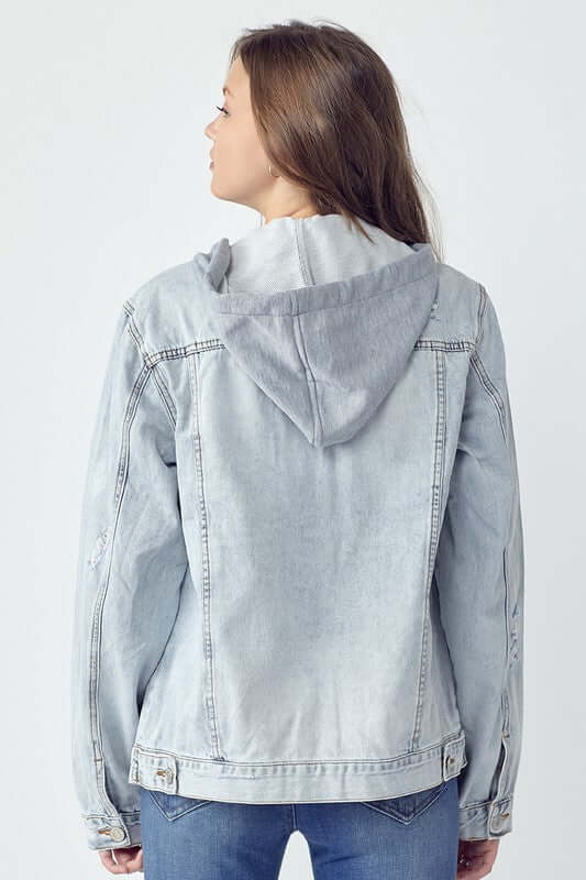 Back view of a woman in a distressed drawstring hooded denim jacket, perfect for a casual and stylish look.