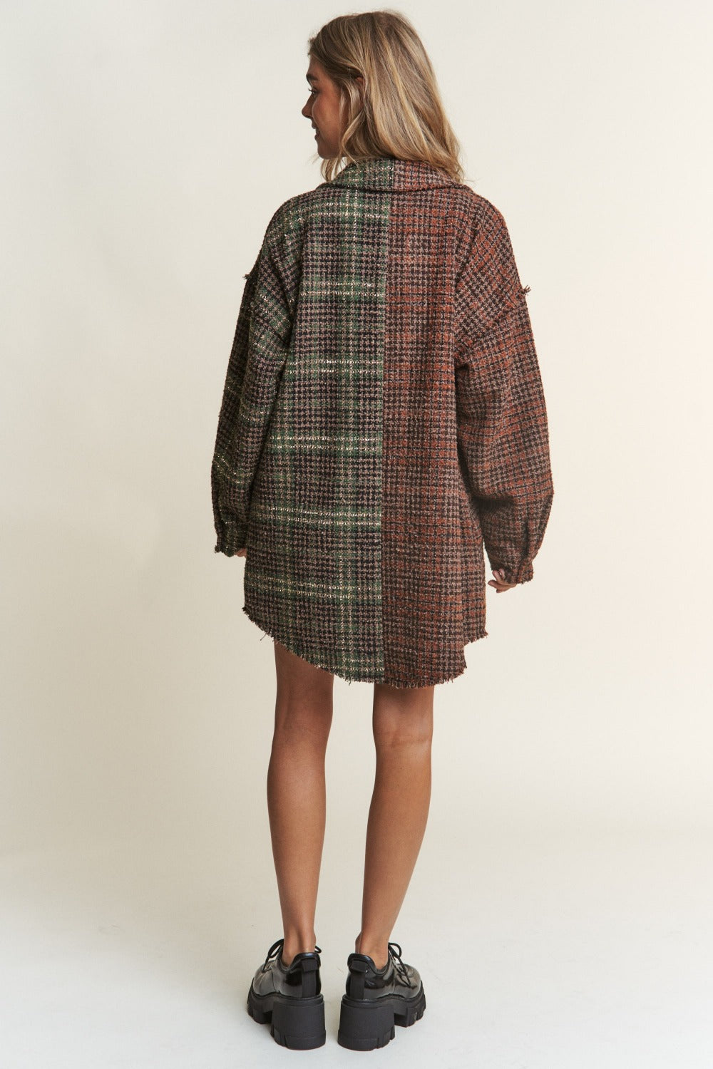 Woman wearing J.NNA tweed plaid longline shacket with contrasting details, perfect for fall layering and stylish comfort.