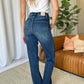 Woman wearing RFM High Rise Straight Tummy Control Jeans in a stylish living room setting.