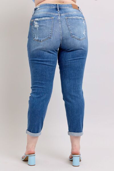 Judy Blue Plus Size Button Fly Distressed Jeans with Pockets, showcasing stylish back view and rolled hems.