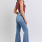 Woman in raw hem high rise bootcut jeans, showcasing a trendy retro style from the back. Perfect for a fashionable look!