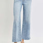 RISEN Full Size Tummy Control High Rise Crop Wide Leg Jeans on model, showcasing high-rise, washed, and slightly stretchy denim with wide-leg cut.