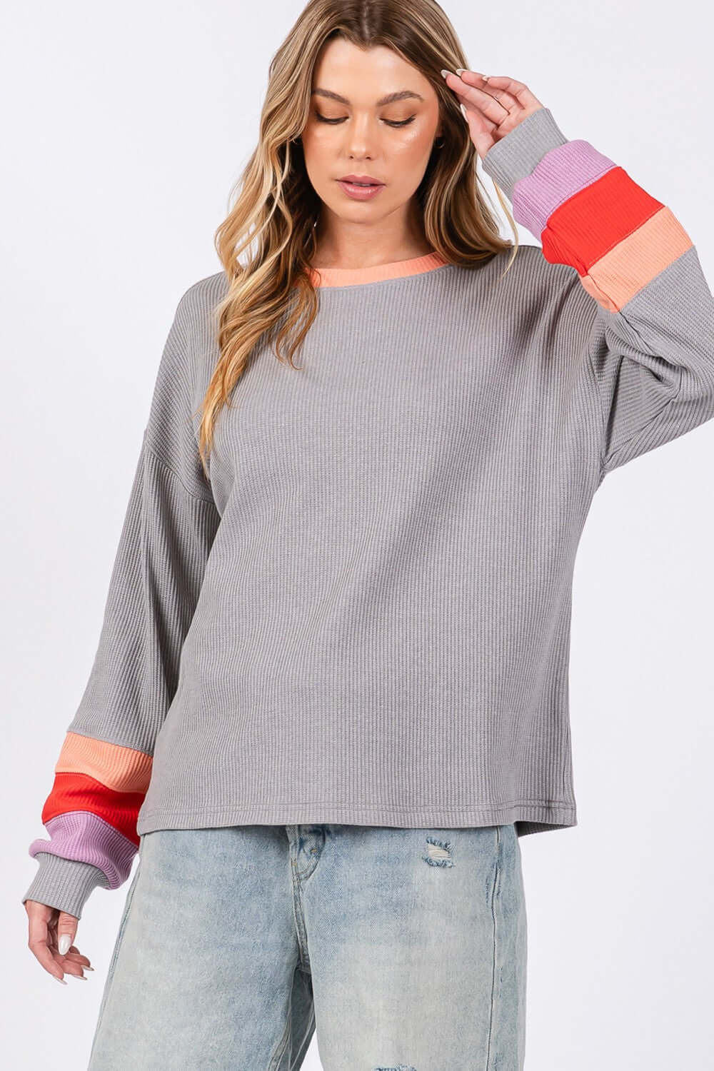 Woman wearing Color Block Waffle Knit T-Shirt with raglan sleeves and a contrast crew neckline. Stylish, casual, and cozy top.