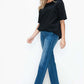 Woman wearing bytos Cat's Whiskers High Rise Straight Jeans with a black top, showcasing a stylish, modern look.