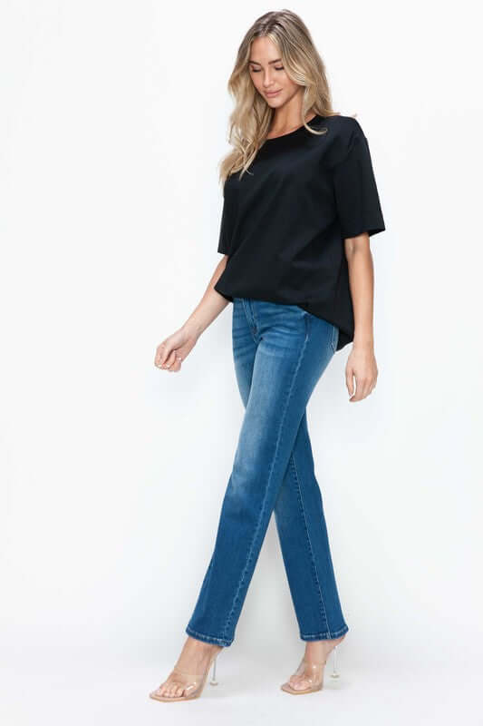 Woman wearing bytos Cat's Whiskers High Rise Straight Jeans with a black top, showcasing a stylish, modern look.