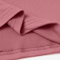 Close-up of the pink round neck short sleeve t-shirt showing stitching detail and fabric texture