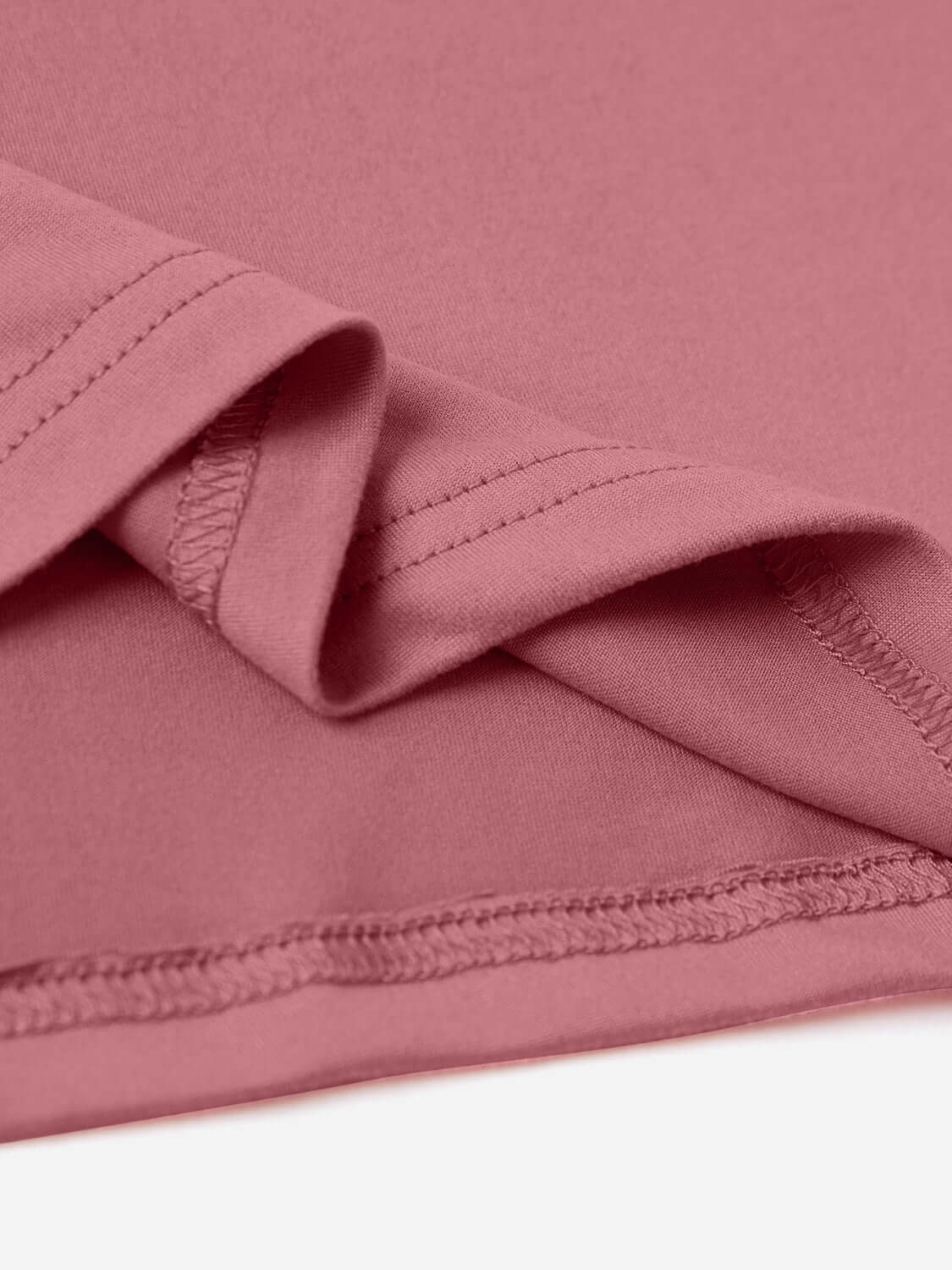 Close-up of the pink round neck short sleeve t-shirt showing stitching detail and fabric texture