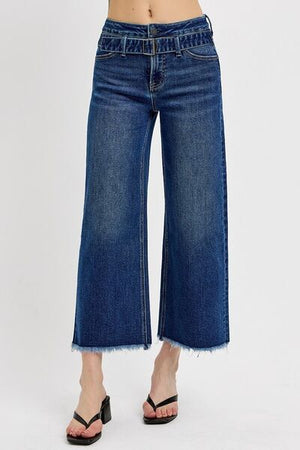 Wide leg raw hem jeans with attached buckle details, perfect for a trendy and relaxed look.