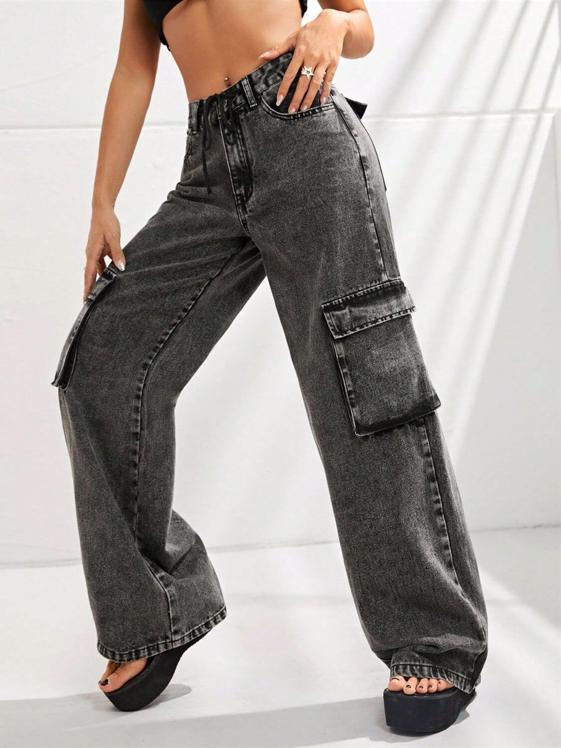 Woman modeling Bella Road wide leg jeans with pockets in dark grey, made from 85% cotton and 15% polyester, no stretch.