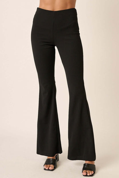 Black flared crepe knit pants with elastic waist for a stylish and comfortable fit. Perfect for versatile day-to-night outfits.