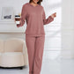 Woman in dusty pink Bella Road hoodie and pants set, holding coffee cup, stylish and cozy lounge wear.