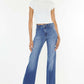 Model wearing Ultra High Waist Gradient Flare Jeans with a white top, showcasing a bold, fashion-forward denim look with a flattering silhouette.