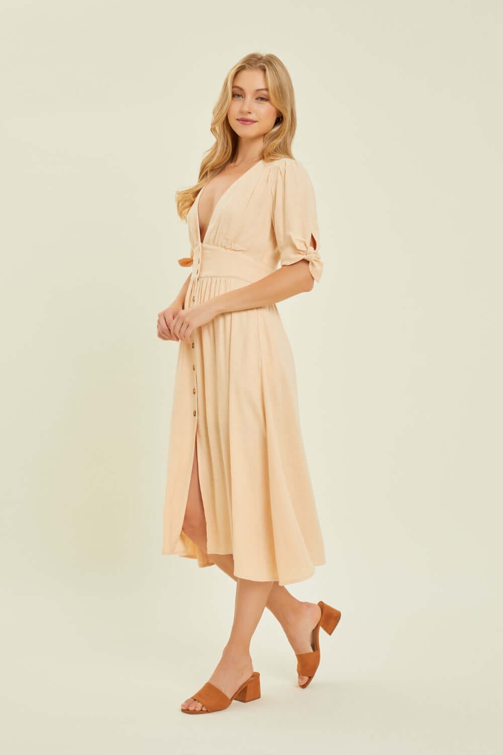 Woman wearing HEYSON Full Size Textured Linen V-Neck Button-Down Midi Dress, perfect for stylish summer elegance.