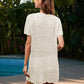 Woman wearing Bella Road Swim Openwork Short Sleeve Cover-Up by a pool surrounded by lush greenery.