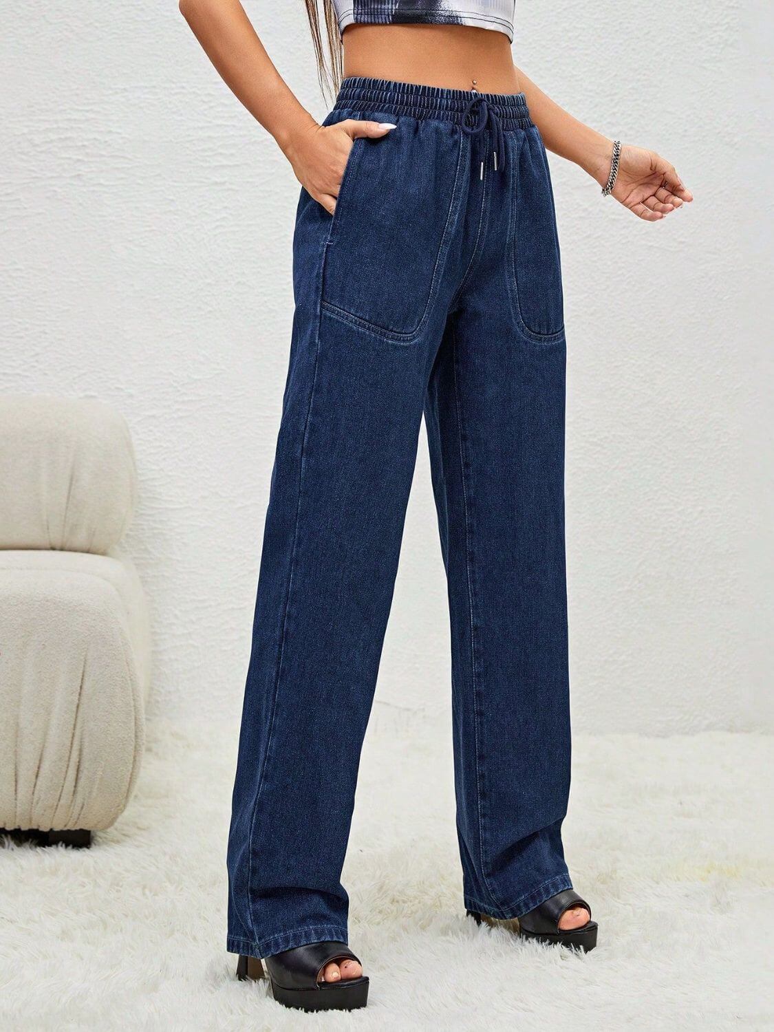 Woman wearing Bella Road Drawstring Elastic Waist Jeans with Pockets, showcasing a comfortable and stylish look.