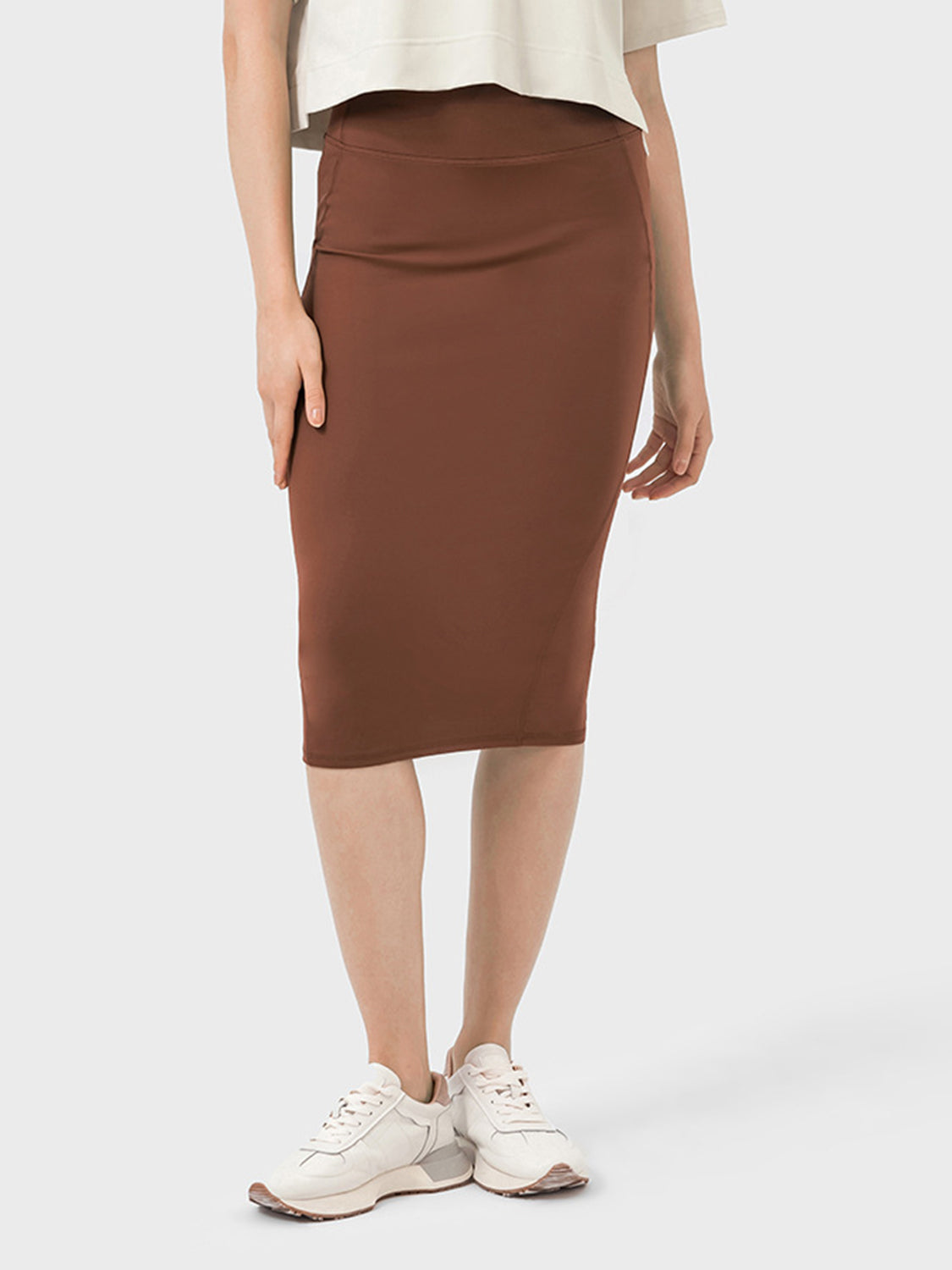 Model wearing a brown Millennia Slit Wrap Active Skirt, perfect for active lifestyles and casual wear.