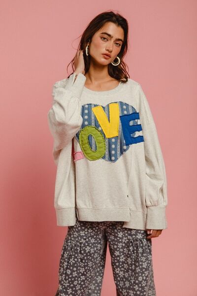 Cozy BiBi LOVE Heart Patch Sweatshirt with colorful letters, paired with comfy pants against a pink backdrop.