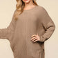 Woman wearing Haptics asymmetric sweater with side slits, long sleeves, and textured knit fabric for a cozy and stylish look.