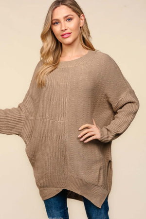 Woman wearing Haptics asymmetric sweater with side slits, long sleeves, and textured knit fabric for a cozy and stylish look.