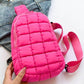 Vibrant pink Bella Road Quilted Nylon Crossbody Bag on denim jacket, perfect for stylish adventures and trendsetting looks.