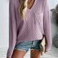 Woman wearing Double Take Pocketed Textured V-Neck Long Sleeve T-Shirt in lavender paired with denim shorts.