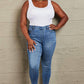 Woman wearing Janavie Full Size High Waisted Pull On Skinny Jeans with a white tank top, showcasing the premium stretch denim and release hem detailing.