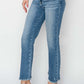 Woman wearing high rise slim straight jeans from Risen Jeans, showcasing a flattering fit and classic denim style with heels.