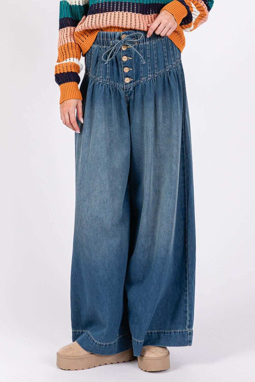 Stylish SAGE+FIG wide leg jeans with smocked waistband and buttons, offering a trendy and comfortable fit for any occasion.