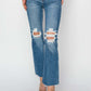 High Rise Distressed Ankle Jeans by Risen Jeans with trendy ripped detailing, perfect for versatile outfits.