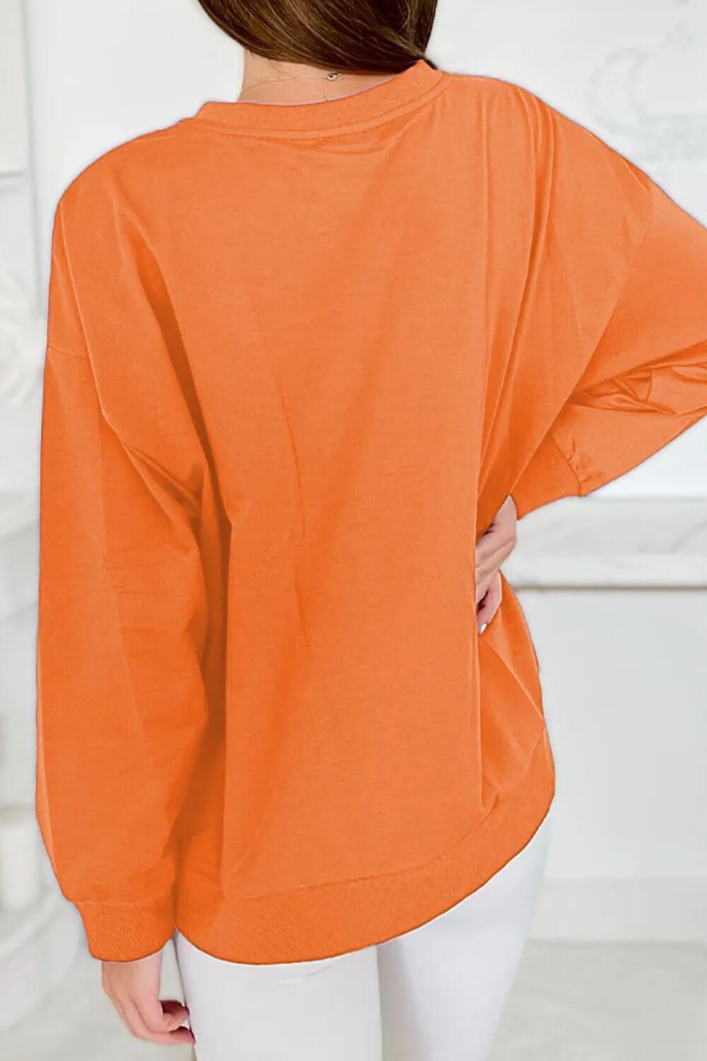 Bella Road Game Day Round Neck Long Sleeve Sweatshirt in orange shown from the back