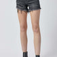 Raw hem denim shorts with pockets by Risen Jeans, perfect for versatile and casual summer styling, shown on a model.