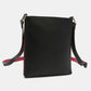 Black Nicole Lee USA Nikky Crossbody Bag made of eco-leather with red accents, featuring a slim design for carrying essentials securely.